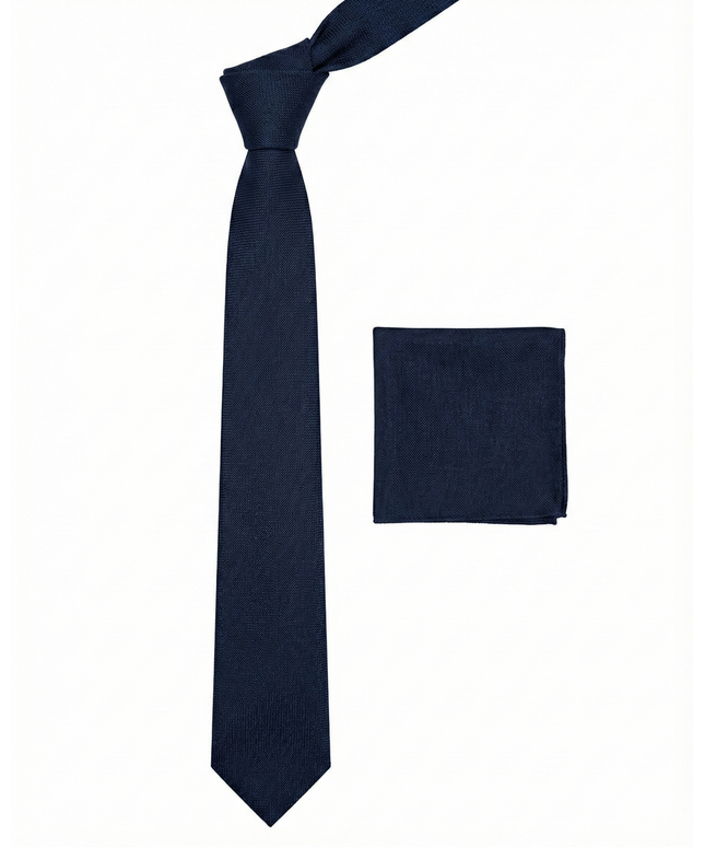 Navy blue tie and matching pocket square on a white background