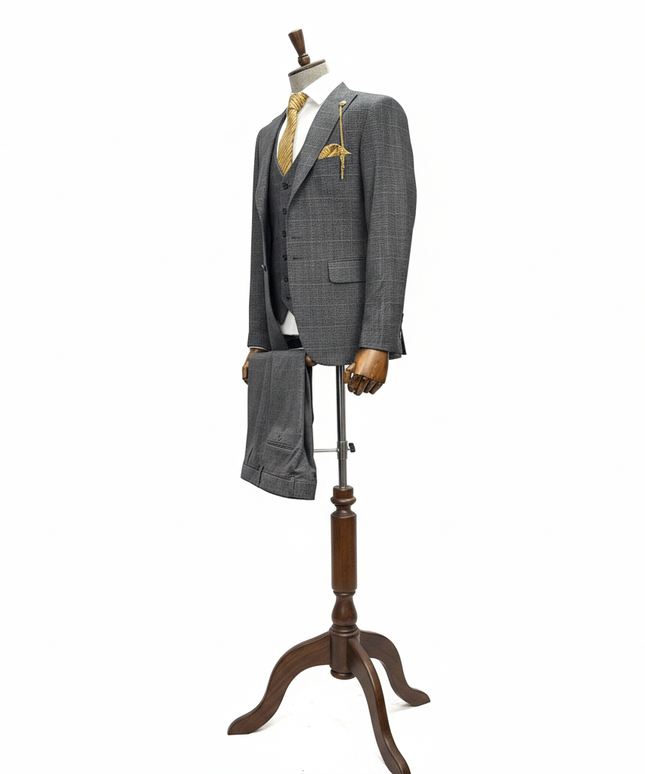 Gray suit on a wooden mannequin stand against a white background