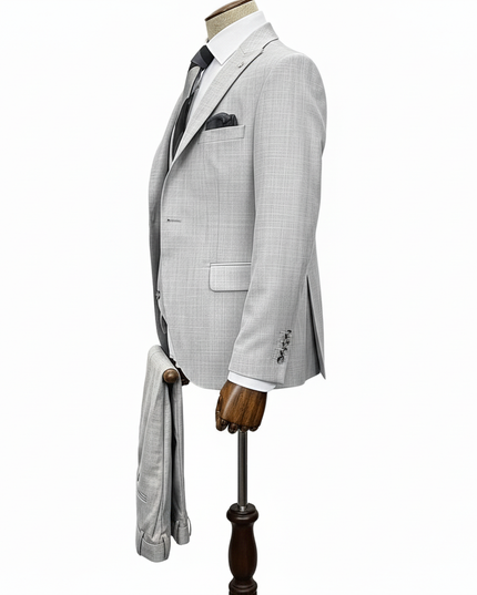 Gray checkered suit jacket on a mannequin with a white background