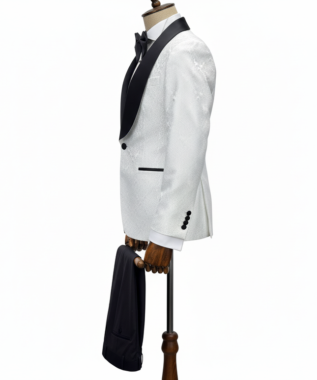White tuxedo jacket with black lapels and bow tie on a mannequin against a white background