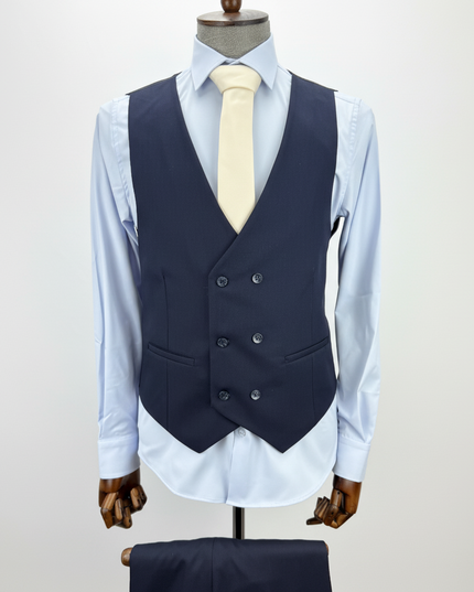 Navy vest over a light blue shirt on a mannequin against a white background
