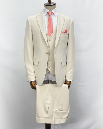 Beige suit with a pink tie on a mannequin against a white background