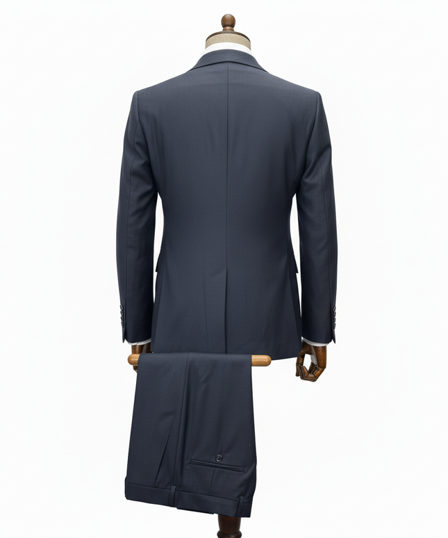 Navy blue overcoat on a mannequin against a white background