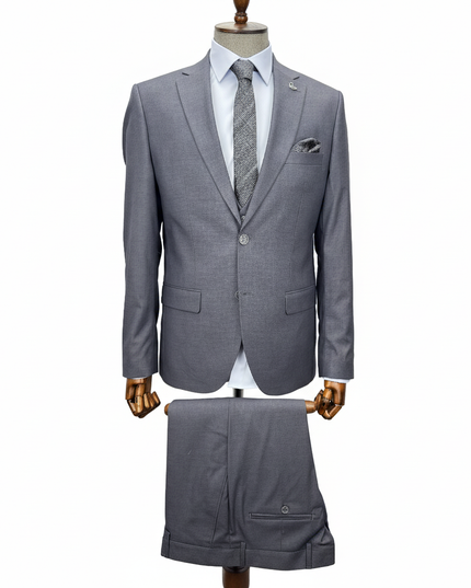 Gray suit on a mannequin with a white shirt and patterned tie against a white background
