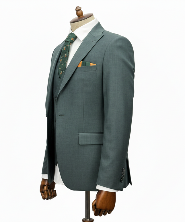 Green suit jacket on a mannequin with a white shirt and patterned tie against a white background