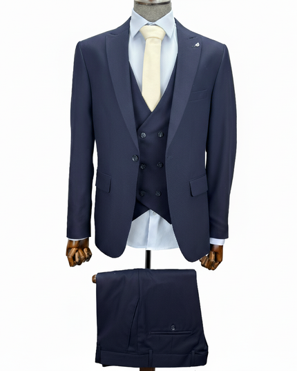 Navy blue suit with white shirt and tie on a mannequin against a white background