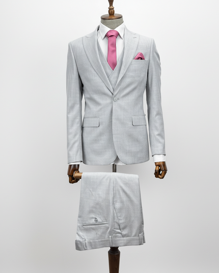 Light gray suit with pink tie on a mannequin against a white background