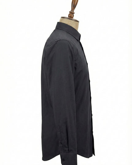 Black shirt on a mannequin against a white background