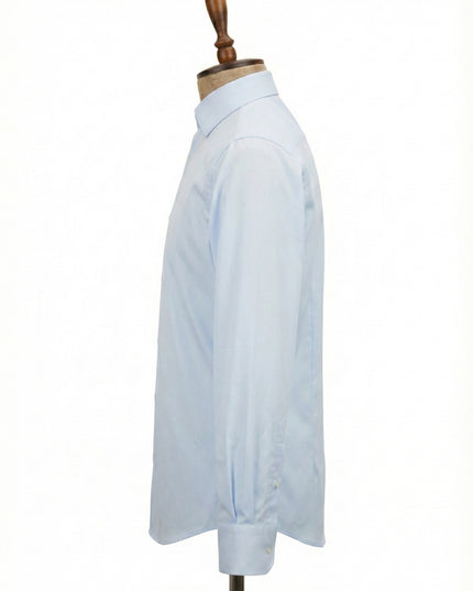 Light blue dress shirt on a wooden mannequin against a white background